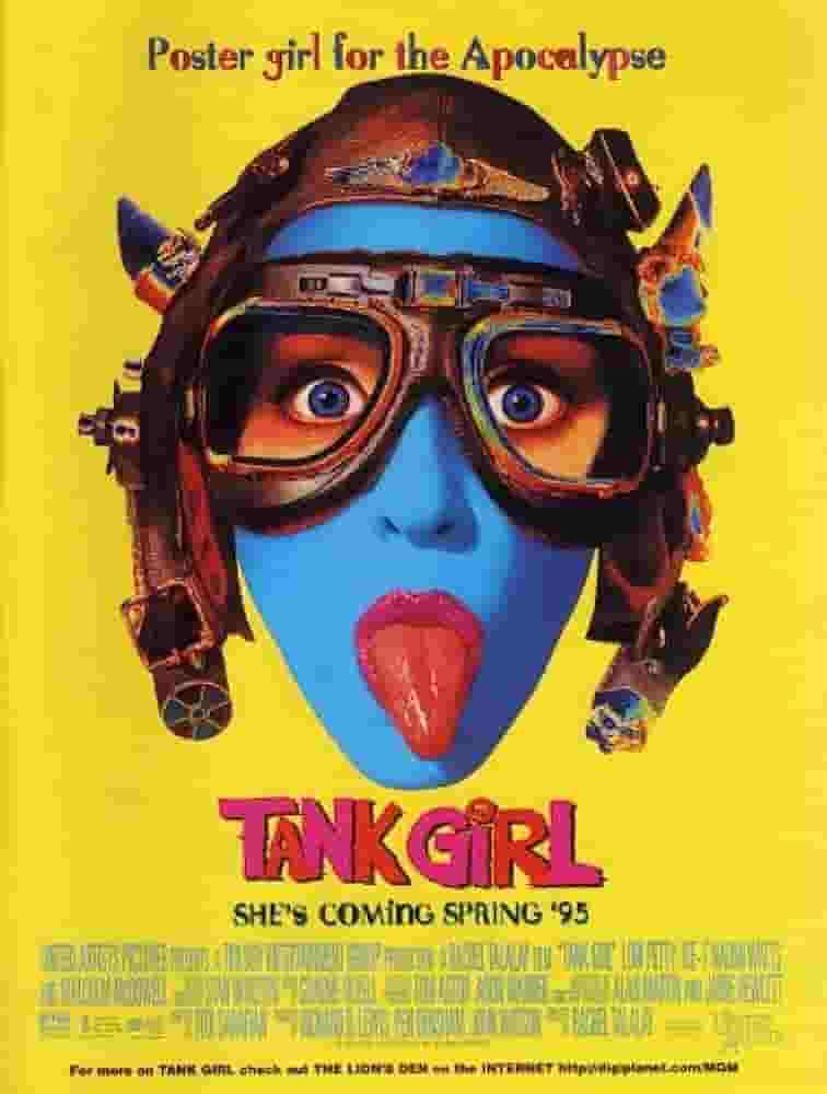 a woman's face with blue skin sticking her tongue out in a steampunk aviator-type hat. the background is bright yellow and the text underneath the image reads 'Tank Girl' and under that reads 'shes coming spring 95'